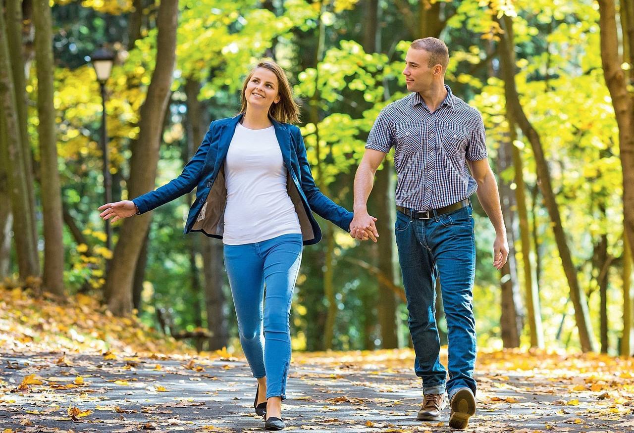 Casual dating in America - couple in park Happy couple walking in the park